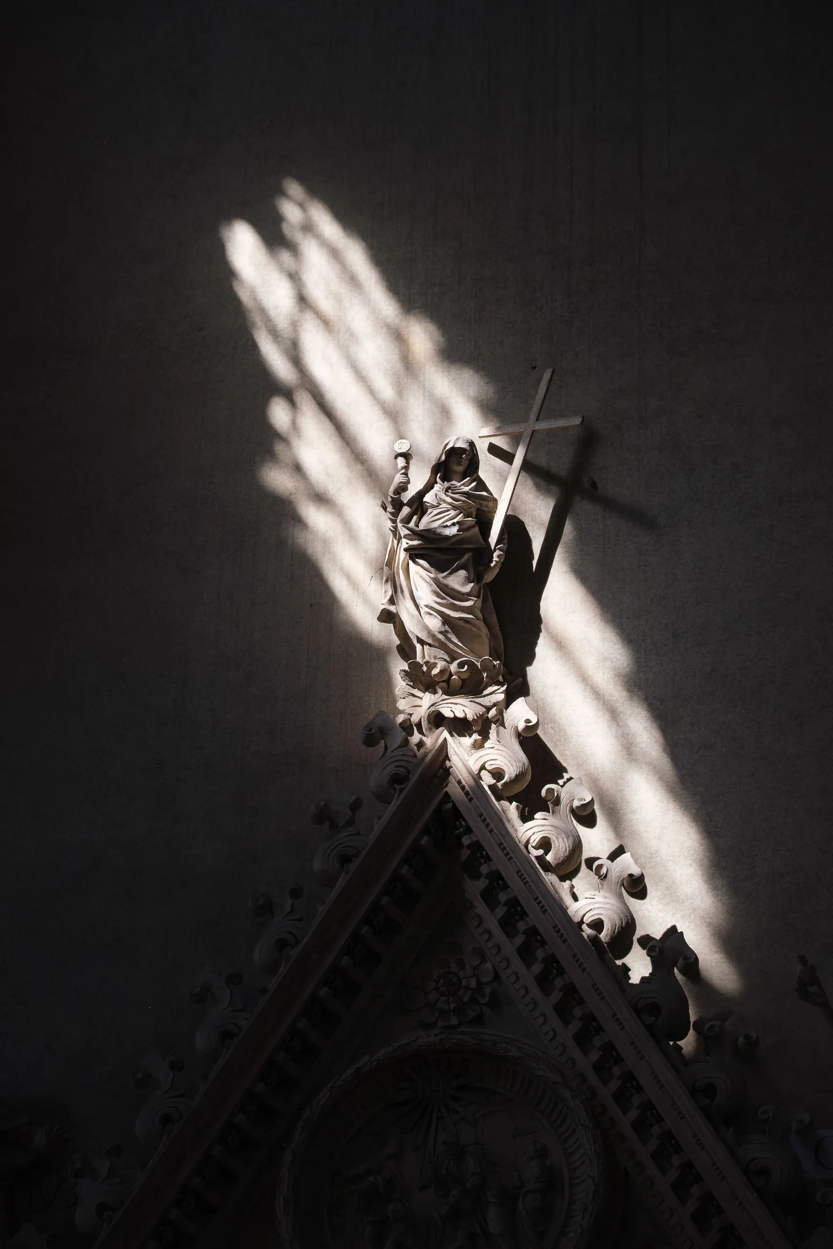 Shafts of light hit statue in the Basilica di San Petronio, Bologna