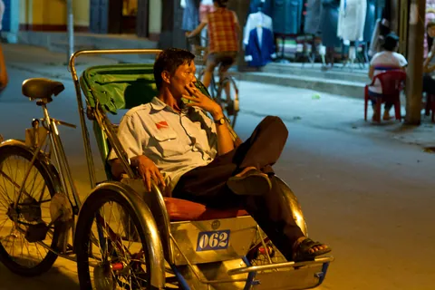 Cyclo driver on a break, Hoi An