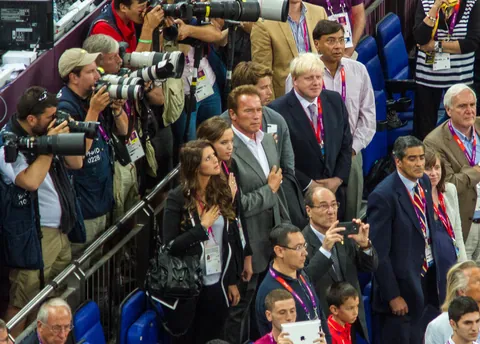 Arnold Schwarzenegger stands for the US national anthem while Boris Johnson looks on, USA Spain Olympic Basketball Final, August 12th 2012