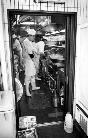 Line cooks underneath Maranouchi Station tracks