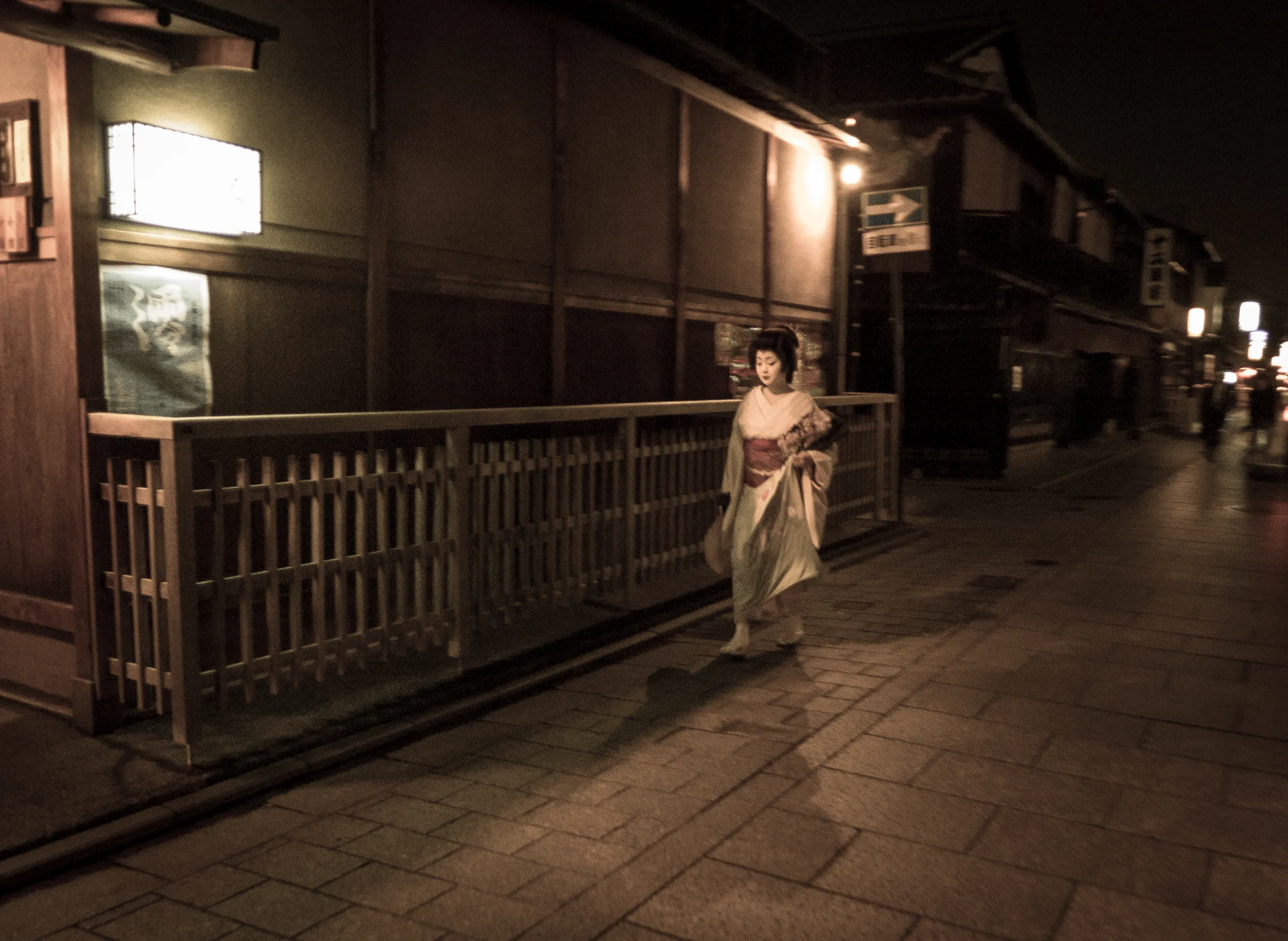 Geisha Suzuko hurries through Gion, Kyoto