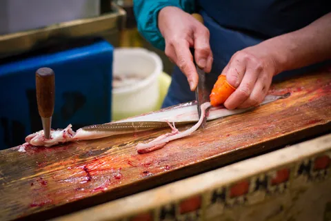Worker filleting a saltwater eel ("anago"), Tsukiji Fish Market
