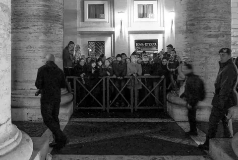 Latecomers held back behind the barricades at Pope Francis' announcement, the Vatican
