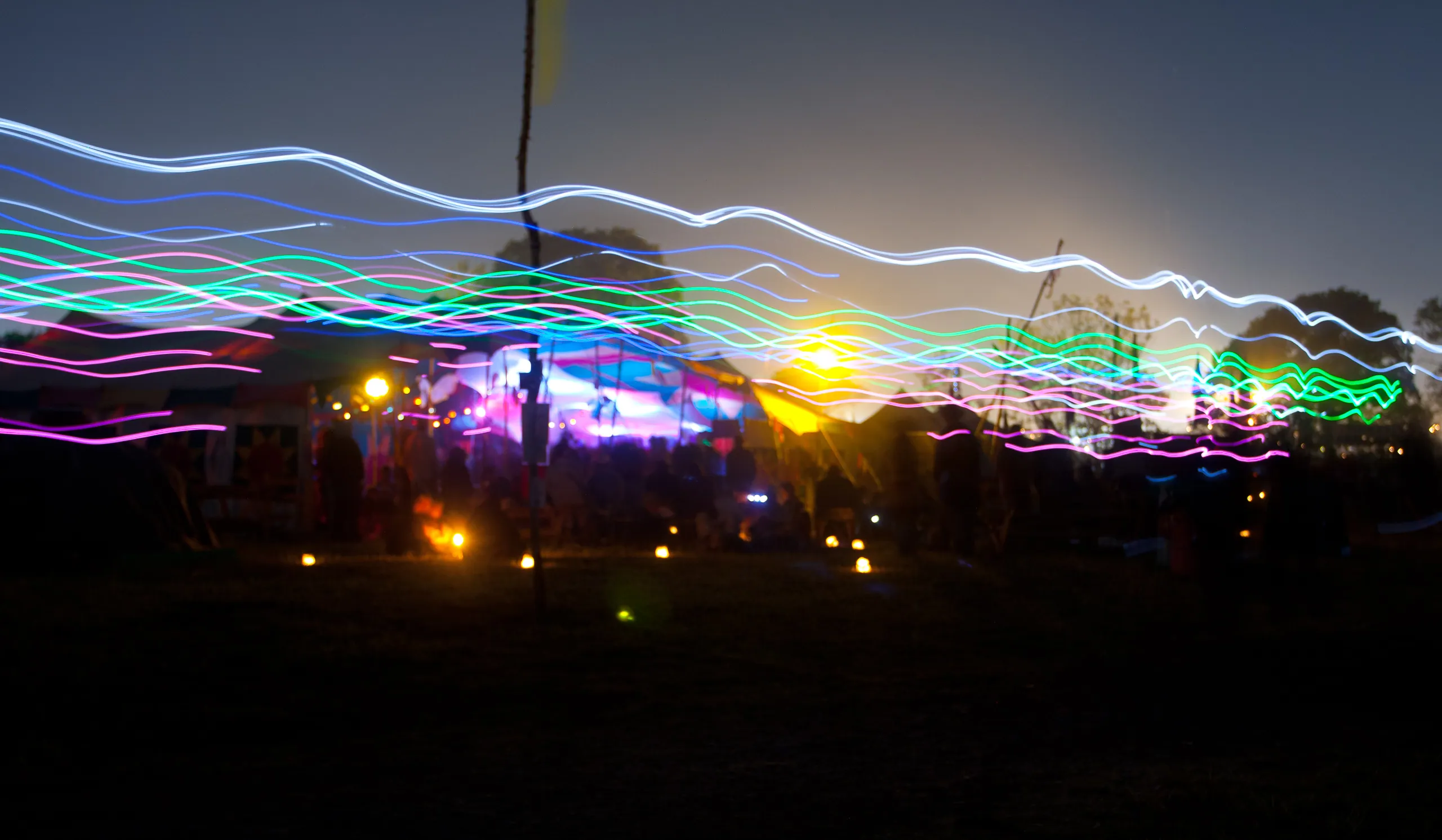 Long exposure of people wearing glowsticks, Green Futures Field