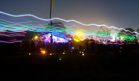 Long exposure of people wearing glowsticks, Green Futures Field